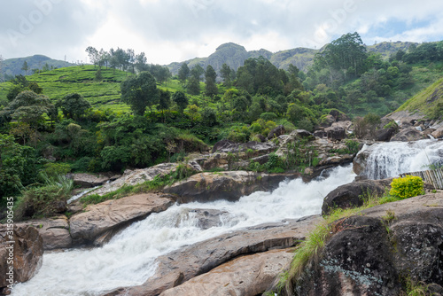 Atukkad Waterfalls near Munnar in Kerala, South India on cloudy day in rain season photo