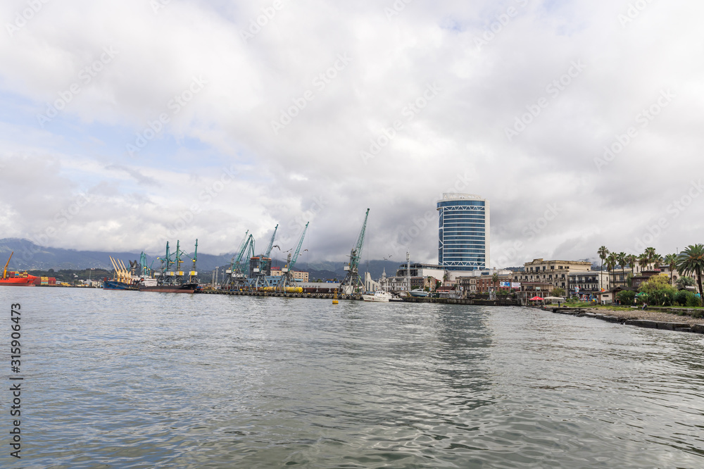 Cargo port on a rainy day on the Black Sea embankment of Batumi city - the capital of Adjara in Georgia