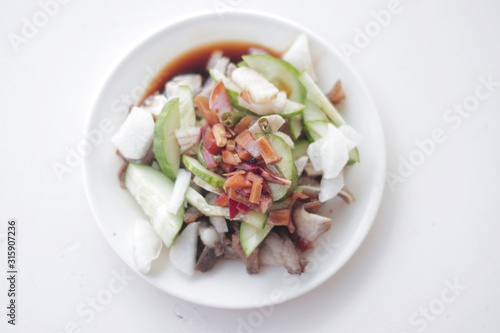 Delicious FIlipino Delicacy called Pork Kilawin or Kinilaw na Baboy on White plate photo