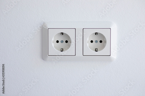 Electrical outlets mounted on a white wall
