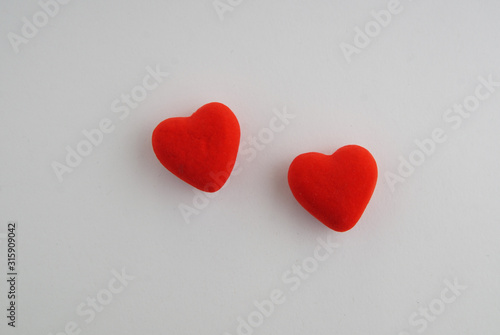 two red hearts on a white background