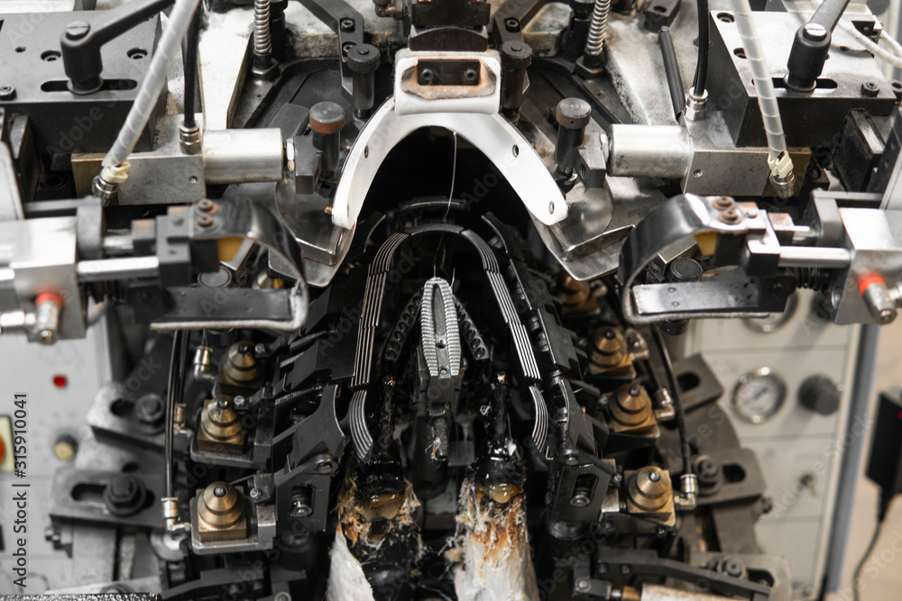 Man use special machine tool for making a shoes. The conveyor on a shoes factory with shoe and sole. Mass production of footwear. Man use special machine tool for making a shoes. The conveyor on a shoes factory with shoe and sole. Mass production of footwear.