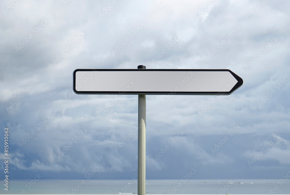 Road sign with empty space for text under cloudy sea sky background Road sign with empty space for text under cloudy sea sky background