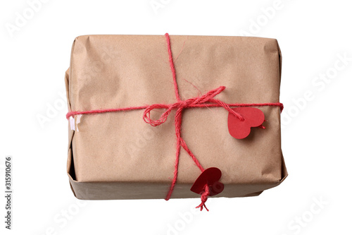 Gift paper box tied with a red rope. Isolated on a white background. Close-up.