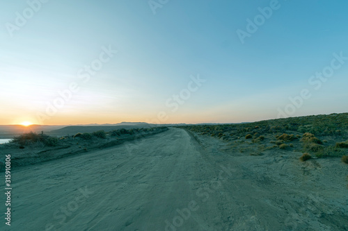 Sunset over gravel road in the Patagonian steppe