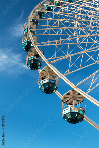 beautiful blue and white ferris wheel among the clouds