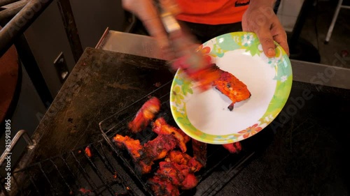 Street food in Malaysian streets at nigh life Chef's hands are cooking chicken wings on oven in sidewalk street food traditional recipes Kuala Lumpur downtown