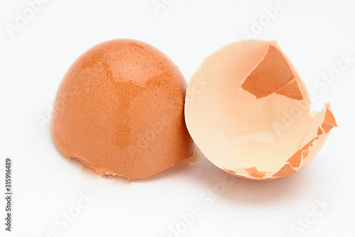 Brown eggshell on a white background close-up