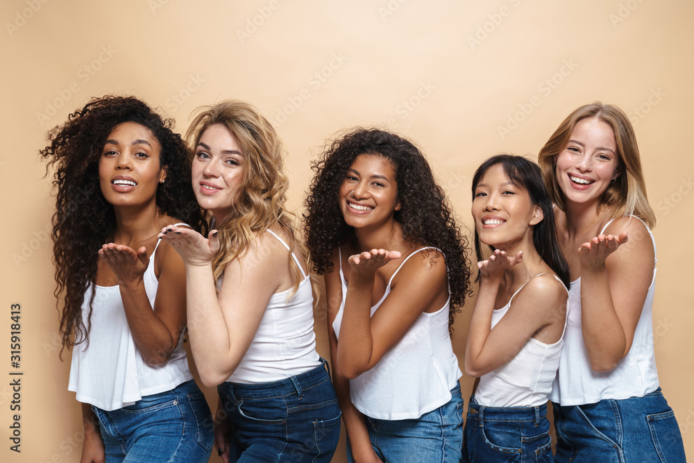 Image of happy multinational women holding copyspace and smiling Image of happy multinational women holding copyspace and smiling