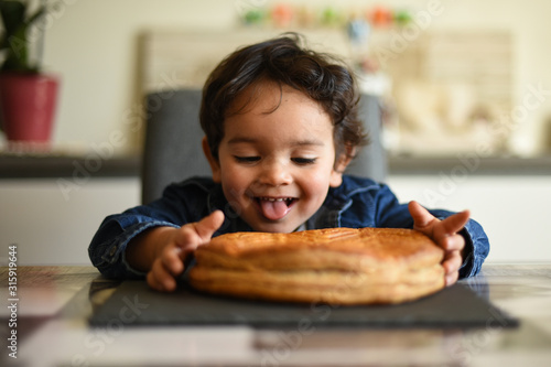 young boy happy to eat kings cake