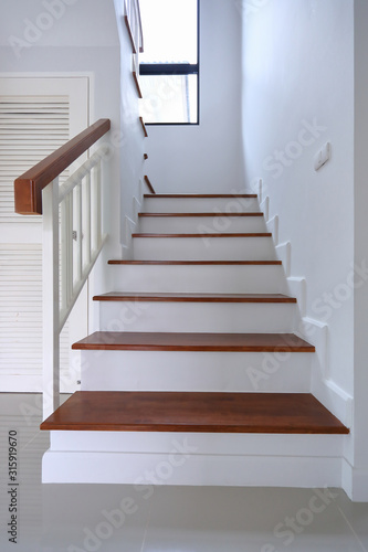 brown wooden stair and white wall in residential house © sutichak