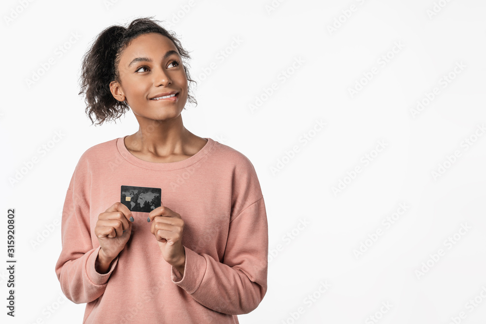 Charming woman afro hairstyle holding plastic credit card isolated over white background Charming woman afro hairstyle holding plastic credit card isolated over white background
