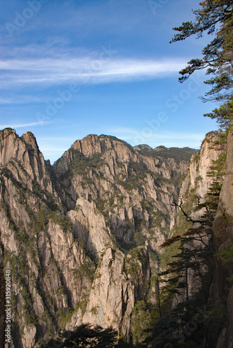 Huangshan Mountain in Anhui Province, China. Between Sanxi Bridge and Fairy Walking Bridge on Huangshan looking through to the West Sea or Xi Hai. Scenic view of peaks on Huangshan Mountain, China.