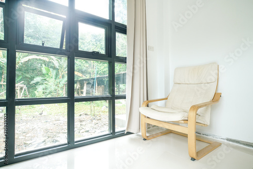 Modern wooden cloth fabric sofa in living room with curtain window background