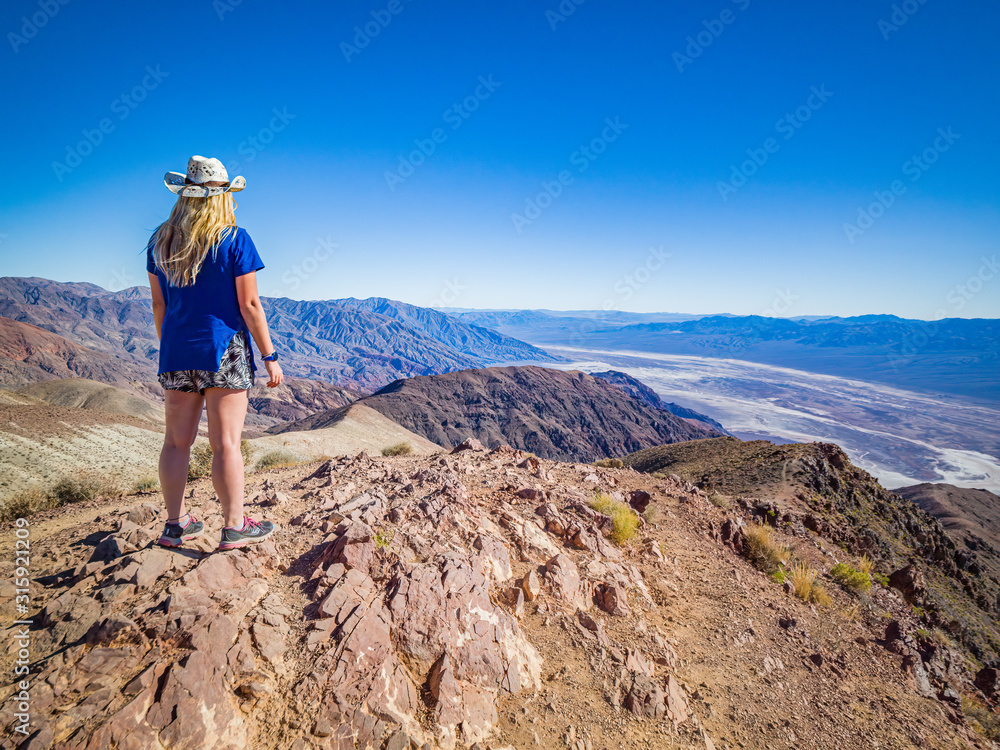 Sexy curvy woman admires the Landscape from the top of Dante's View in Death Valley National Park in California. It is one of the hottest places in the world.