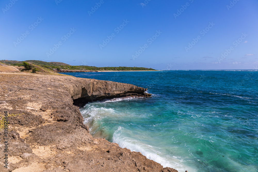 Sainte-Anne, Martinique, FWI - Ferré Cape - Waves on the rocks in Pointe La Rose - Anse Baleine beach in the background