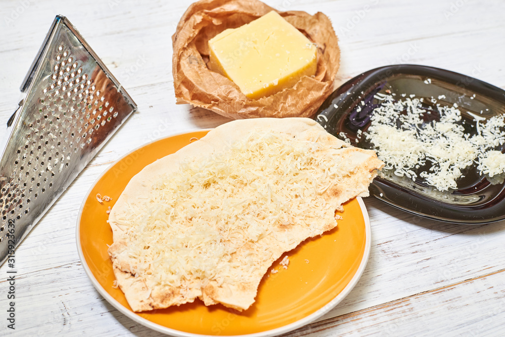 Round pita bread and cheese. Cooking snacks. Round pita bread and cheese. Cooking snacks.