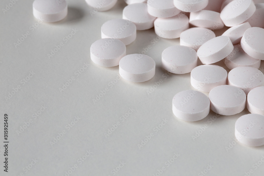 Pills tablets vitamins capsules drugs white close up macro shot
