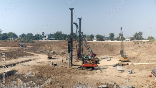 drilling piles with heavy machineries at the construction site