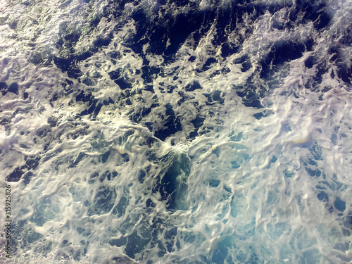 Foamy blue and turquoise seawater background texture