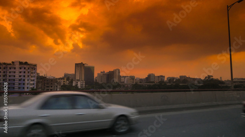 Side view of a car on the streets of Dhaka, Bangladesch at sunset