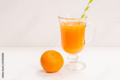 Fresh tropical fruits and glass of juice on white background.