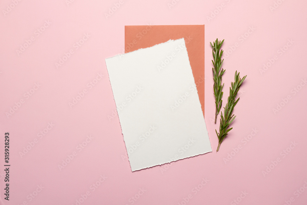 Minimalistic elegant templates for wedding invitations, birthdays. The view from the top. Card made of white paper, envelope, gold elements, sprigs of rosemary on the background - pink paper. Mock-up. Minimalistic elegant templates for wedding invitations, birthdays. The view from the top. Card made of white paper, envelope, gold elements, sprigs of rosemary on the background - pink paper. Mock-up.
