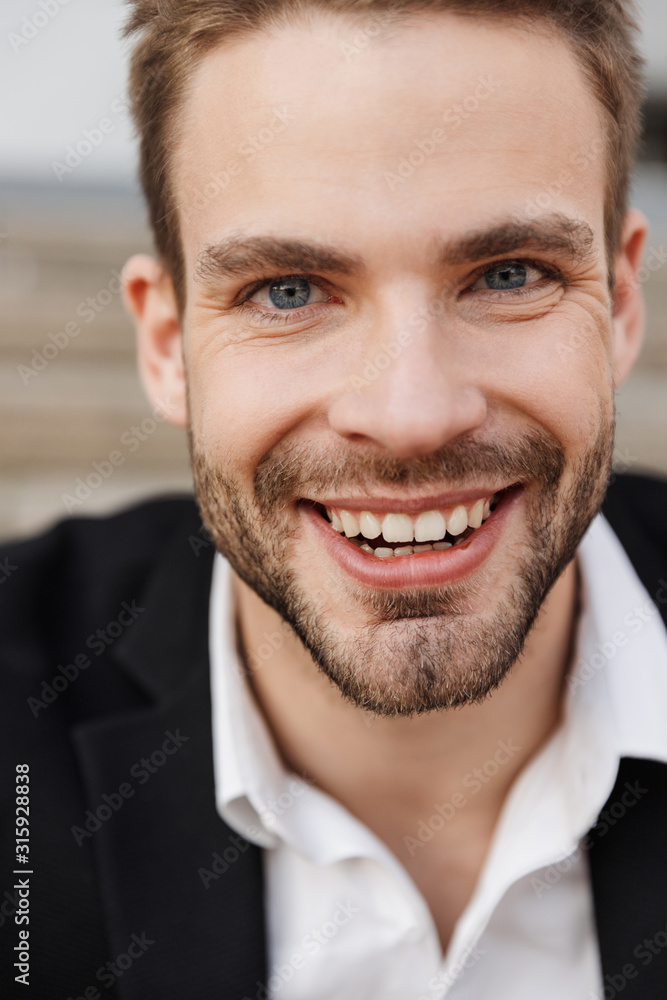 Close up of a handsome smiling young businessman Close up of a handsome smiling young businessman