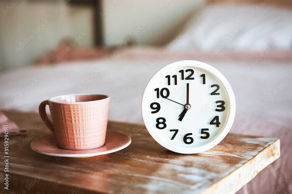 Cup of coffee or tea with white alarm clock Cup of coffee or tea with white alarm clock