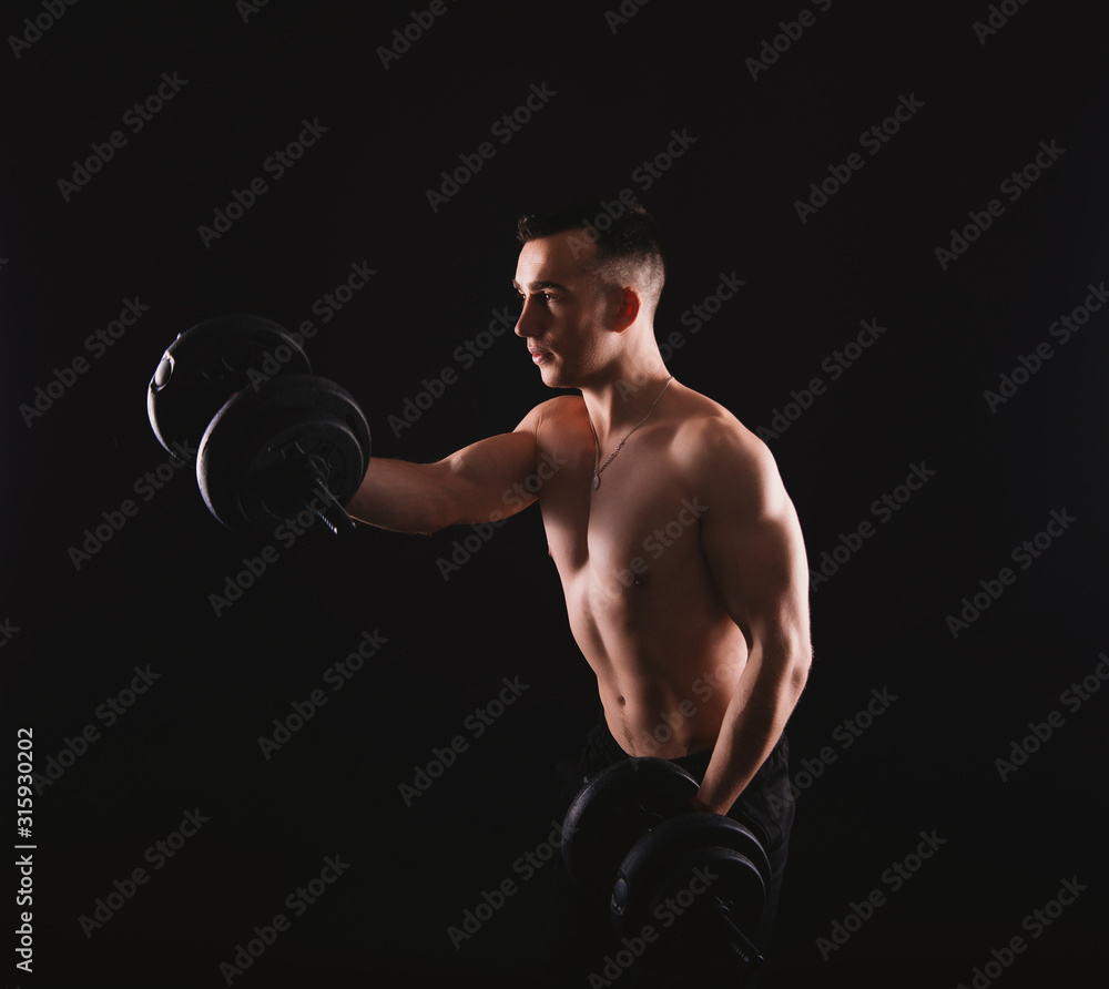 Photo of young man working at his biceps with dumbbells