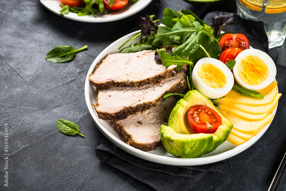 Keto diet plate on black stone table. Keto diet plate on black stone table.