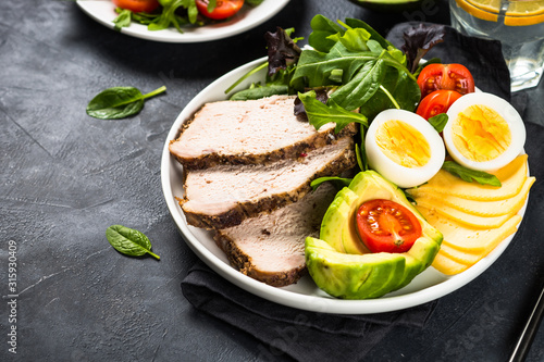 Keto diet plate on black stone table.