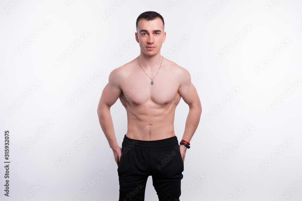 Photo of fitness young man posing over white background Photo of fitness young man posing over white background