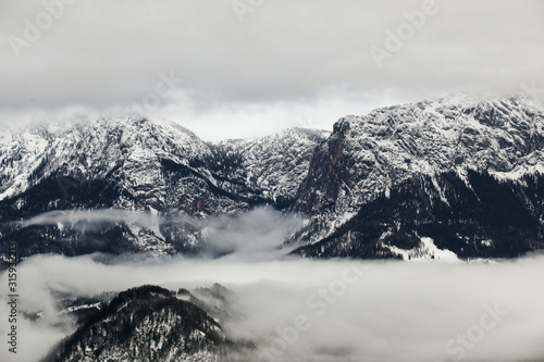 Beautiful fog in the high, rocky mountains in winter. © Mykola Romanovsky