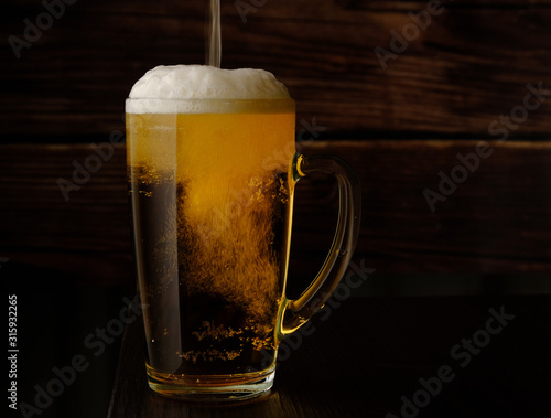 beer is poured into a beer mug