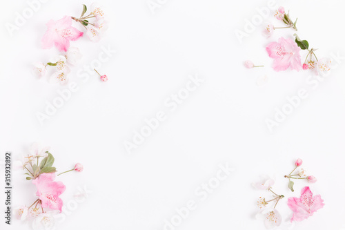 Festive flower composition on the white wooden background. Overhead view © Olga Ionina