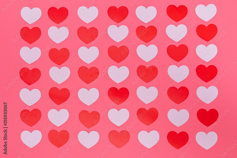 a lot of red and white small hearts put entire a picture and in a cross chess pattern, those are put on a pink background