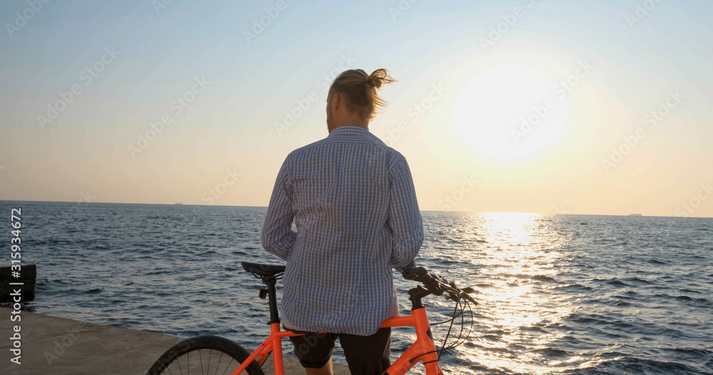 custom made wallpaper toronto digitalYoung handsome male in casual wear ride on the colorful bicycle on the morning beach against beautiful sunset and the sea