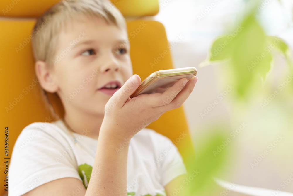 boy makes voice search on the smartphone, phone and gadget addiction boy makes voice search on the smartphone, phone and gadget addiction