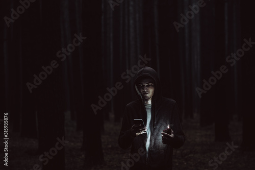 The concept of a telephone Stalker or kidnapper in the misty forest, toned noisy photos © pavelkant