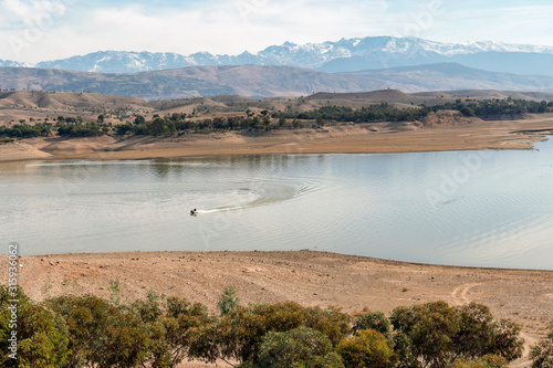 Motorboat on beautiful lake south from Marrakech, Morocco photo