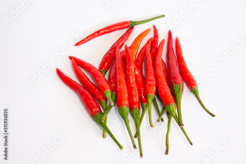 red chili peppers isolated on white background. Isolated closeup of fanned-out Red Hot Chili Peppers (the food, not the band) against a white background with stems up.