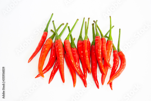 red chili peppers isolated on white background. Isolated closeup of sixteen (16) fanned-out Red Hot Chili Peppers (the food, not the band) against a white background with stems up.