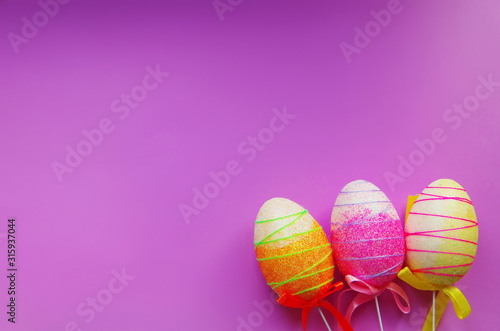 decorative Easter eggs on purple background
