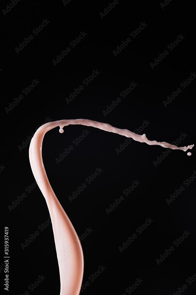 smooth fresh pink milk splash with drops isolated on black smooth fresh pink milk splash with drops isolated on black