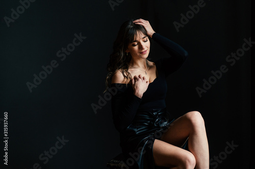 dramatic portraits with sensual brunette woman posing in the dark