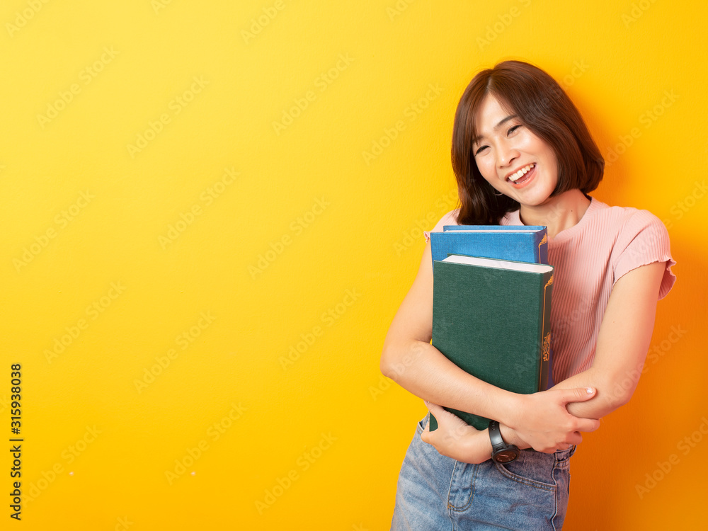 Beautiful asian woman University student happy on yellow background Beautiful asian woman University student happy on yellow background