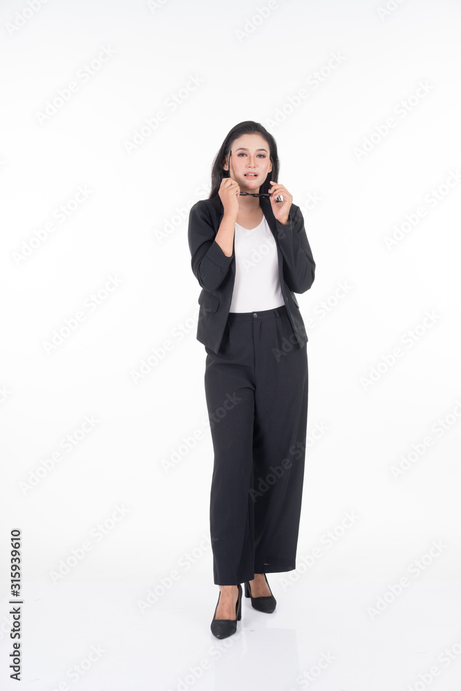 A portrait of a beautiful businesswoman in a black and white officewear and sunglasses isolated on white background. A portrait of a beautiful businesswoman in a black and white officewear and sunglasses isolated on white background.