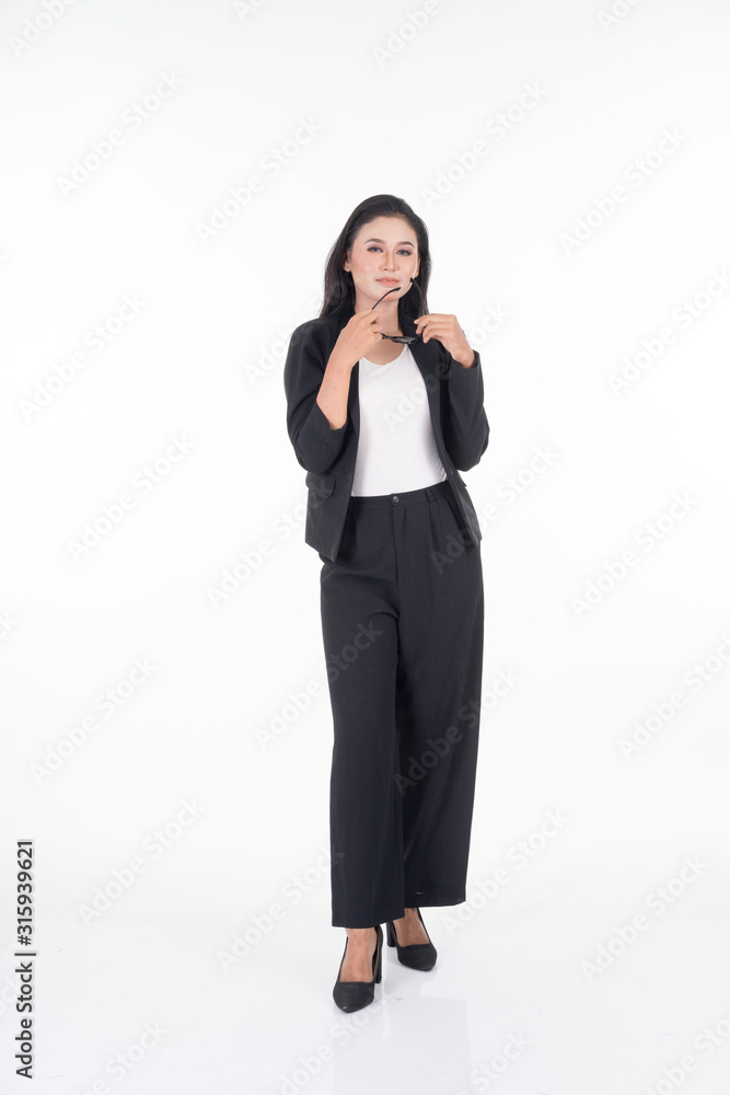 A portrait of a beautiful businesswoman in a black and white officewear and sunglasses isolated on white background. A portrait of a beautiful businesswoman in a black and white officewear and sunglasses isolated on white background.