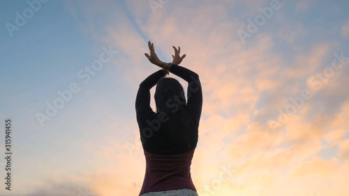 Happy female dance in the summer fields during beautiful sunset	